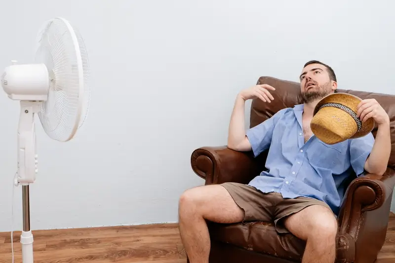 man in front of fan man in front of fan